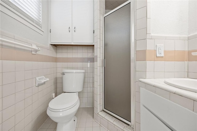4414 Driftwood Pl, Corpus Christi, TX 78411 - full bath with tile walls, a stall shower, toilet, tile patterned flooring, and vanity