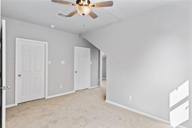 interior space featuring light carpet, ceiling fan, and lofted ceiling