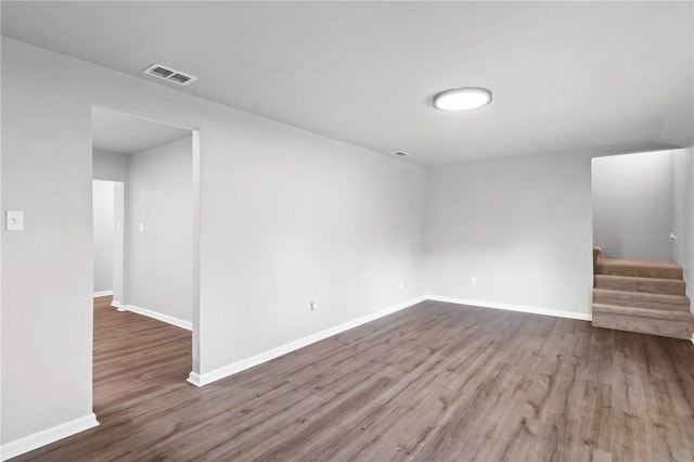 unfurnished room with dark hardwood / wood-style flooring