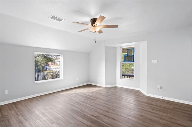 unfurnished room with a wealth of natural light, dark wood-type flooring, ceiling fan, and lofted ceiling