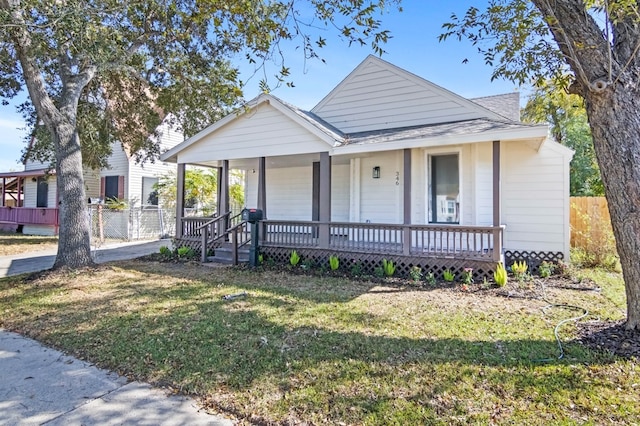 bungalow-style house featuring a porch and a front yard