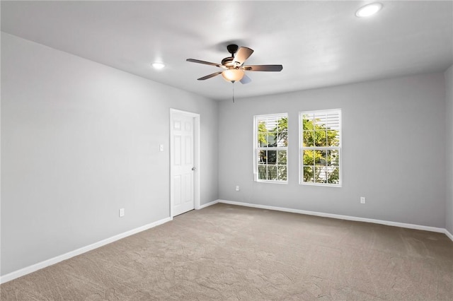 empty room with ceiling fan and carpet floors