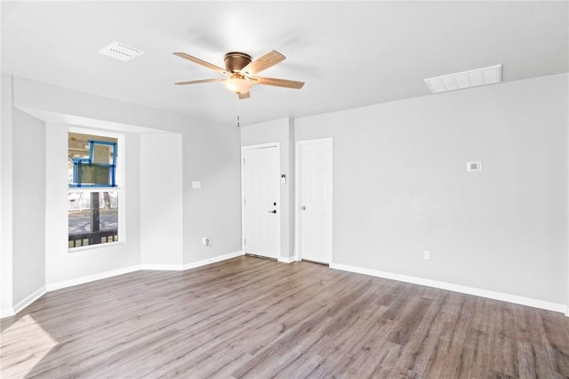 empty room featuring ceiling fan and light wood-type flooring