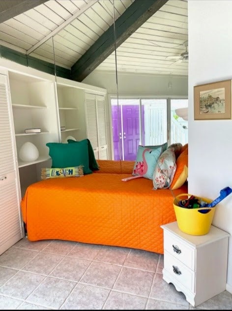1878 Bay Shore Dr, Rockport, TX 78382 - bedroom with beam ceiling, wooden ceiling, a closet, and tile patterned floors