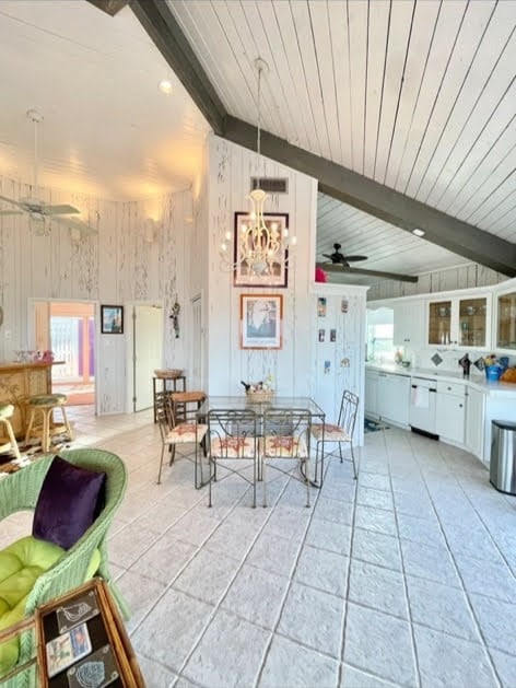 1878 Bay Shore Dr, Rockport, TX 78382 - dining area featuring a wealth of natural light, vaulted ceiling with beams, and ceiling fan with notable chandelier