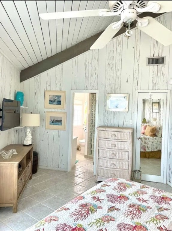 1878 Bay Shore Dr, Rockport, TX 78382 - tiled bedroom featuring lofted ceiling with beams, visible vents, ensuite bath, and wooden ceiling