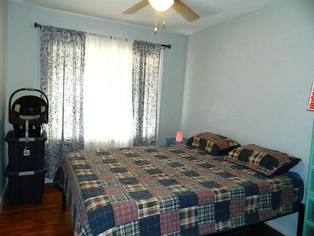 bedroom with ceiling fan and dark hardwood / wood-style floors