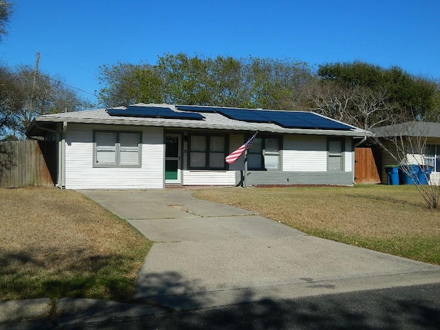 single story home with solar panels and a front lawn