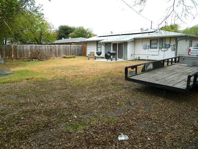 view of yard with a wooden deck and a patio area