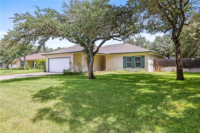 single story home featuring a garage and a front lawn