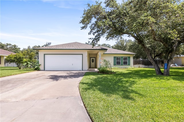 view of front of property with a garage and a front yard