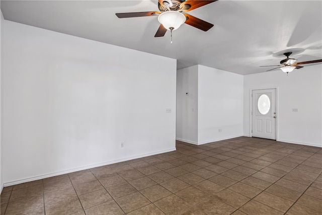 tiled spare room with ceiling fan