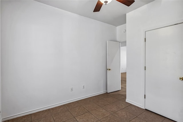 unfurnished bedroom featuring ceiling fan and tile patterned flooring