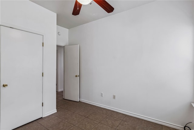 unfurnished bedroom featuring ceiling fan, tile patterned floors, and a closet