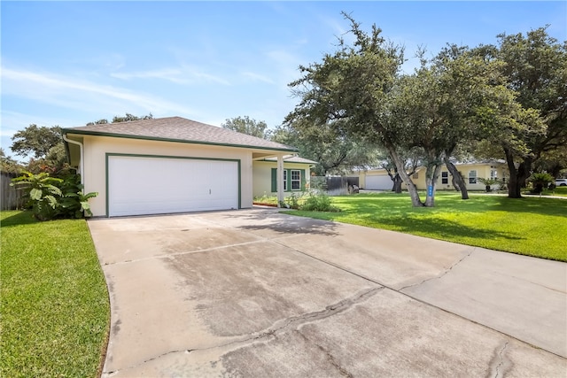 single story home featuring a garage and a front lawn