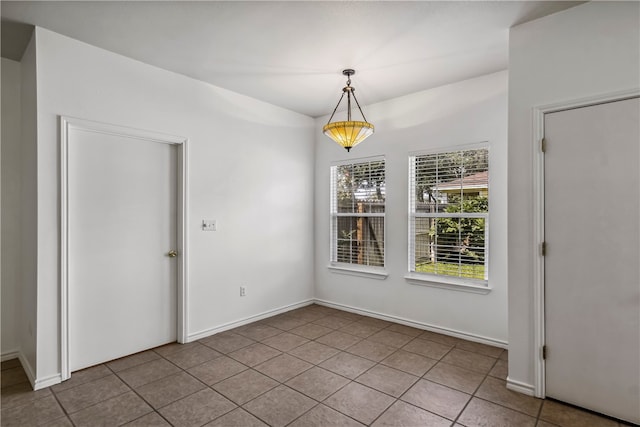 unfurnished dining area featuring tile patterned flooring