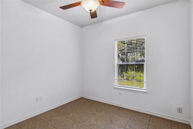 spare room featuring ceiling fan and tile patterned floors