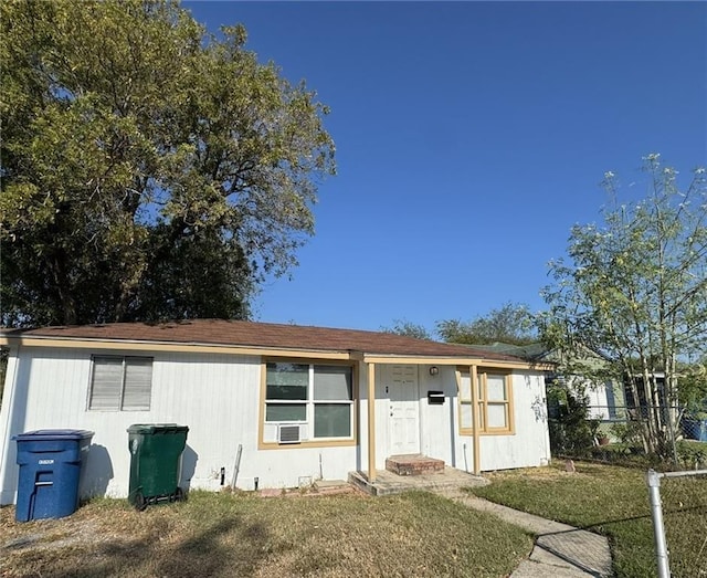 ranch-style home featuring a front yard and fence