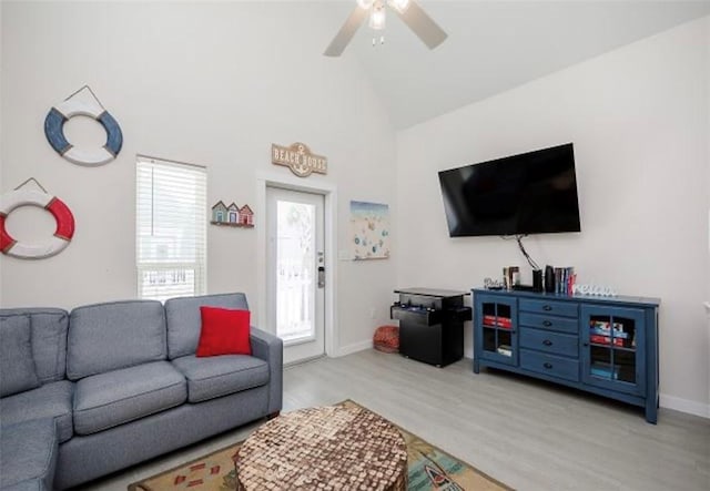 living room featuring light wood-type flooring, ceiling fan, and high vaulted ceiling