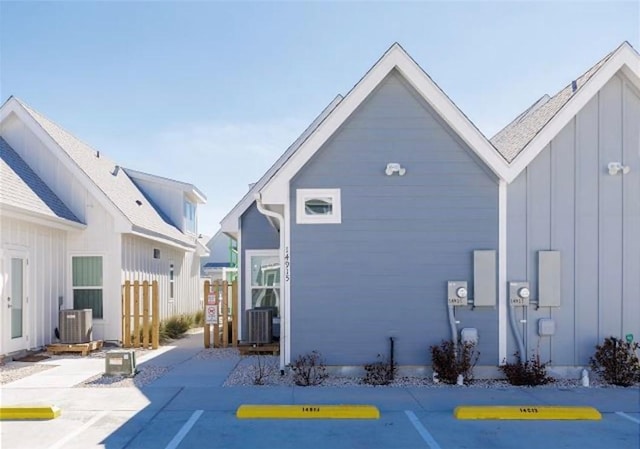 rear view of property featuring central air condition unit