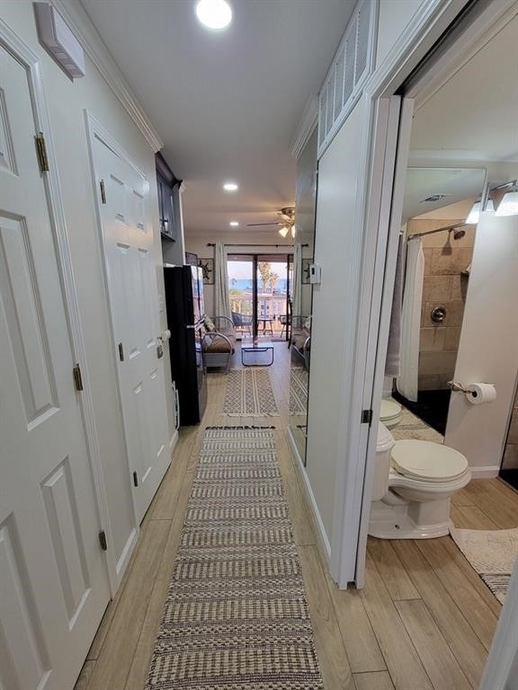 hallway with light hardwood / wood-style flooring