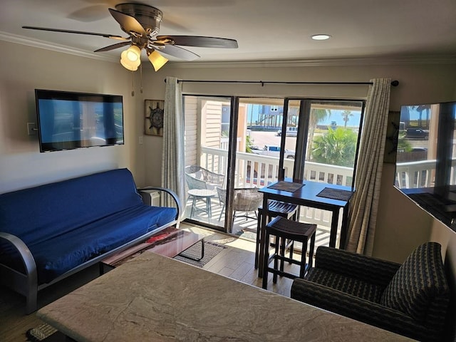 living room with ornamental molding, a wealth of natural light, ceiling fan, and light hardwood / wood-style floors