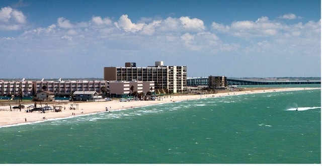 birds eye view of property featuring a water view and a beach view