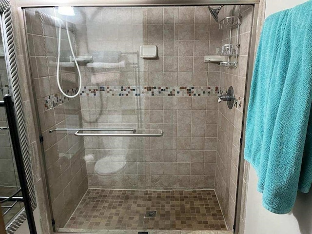 bathroom featuring a shower with door