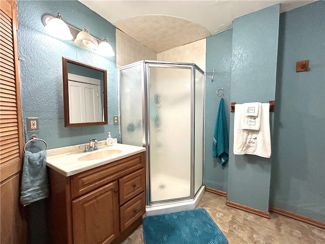 bathroom featuring walk in shower and vanity