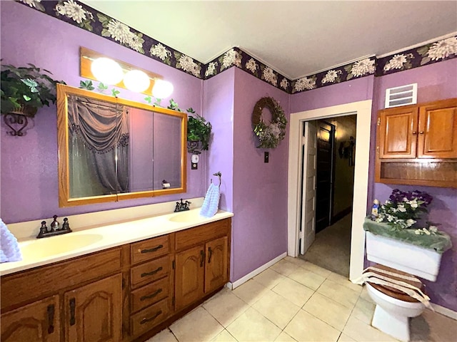 bathroom featuring toilet, vanity, and tile patterned flooring