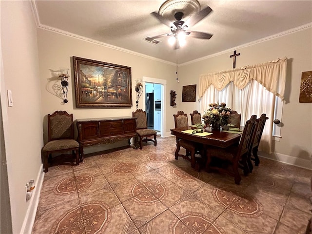 dining space with ceiling fan, tile patterned floors, and crown molding