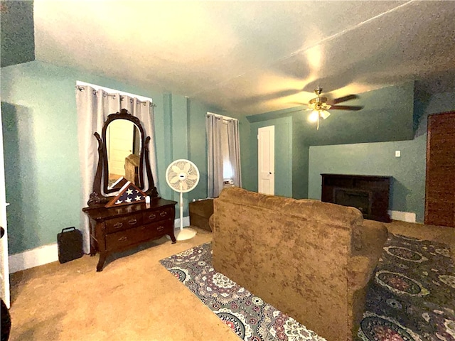 living room with ceiling fan and carpet