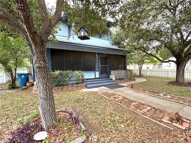 view of front of home with a sunroom