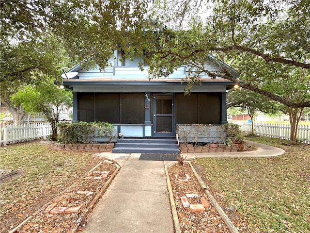 view of front of home with a sunroom