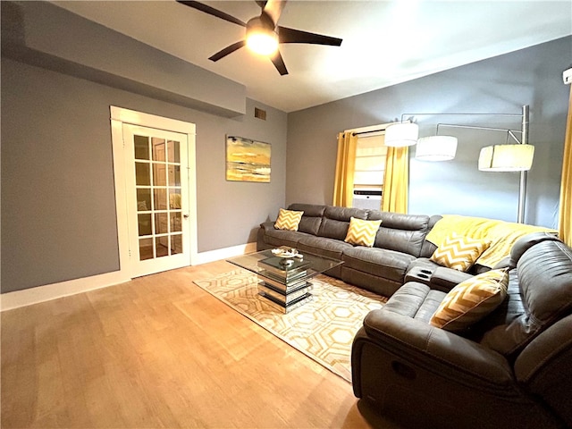 living room featuring hardwood / wood-style flooring and ceiling fan