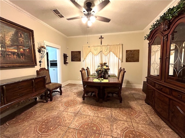 dining area with ceiling fan, a textured ceiling, tile patterned floors, and ornamental molding