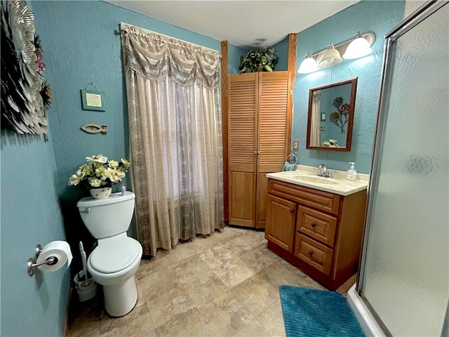 bathroom featuring walk in shower, vanity, and toilet