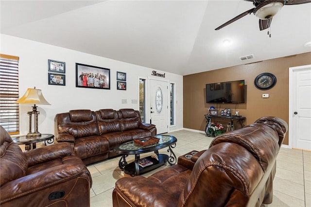 living room with ceiling fan, light tile patterned floors, and lofted ceiling