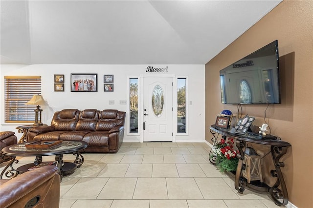 tiled foyer entrance featuring vaulted ceiling