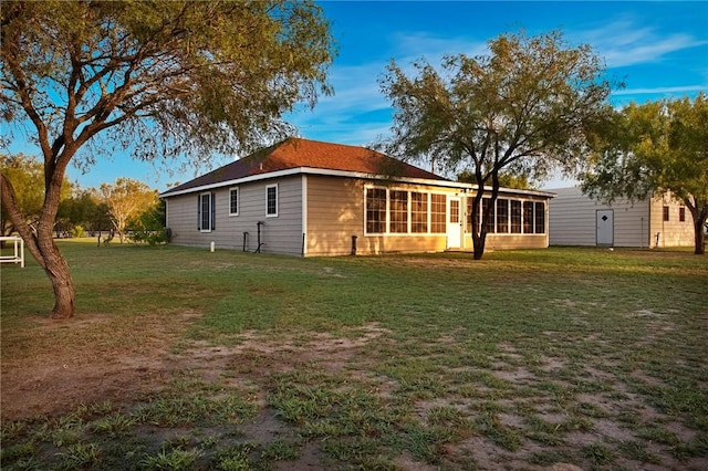 exterior space with a sunroom and a lawn