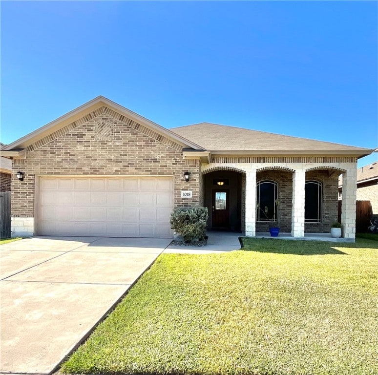 view of front of property with a front yard and a garage