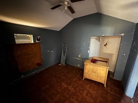 interior space featuring lofted ceiling, ceiling fan, and dark parquet floors