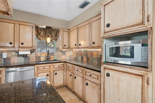 11809 Lori Dr, Corpus Christi, TX 78410 - kitchen with stainless steel appliances, a sink, light brown cabinets, and decorative backsplash