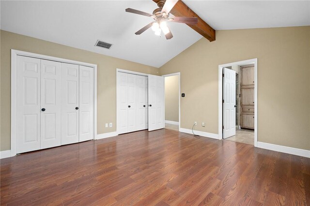 11809 Lori Dr, Corpus Christi, TX 78410 - unfurnished bedroom with two closets, wood finished floors, and baseboards