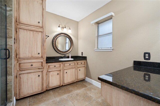 11809 Lori Dr, Corpus Christi, TX 78410 - full bath with baseboards, vanity, stone tile floors, and a stall shower