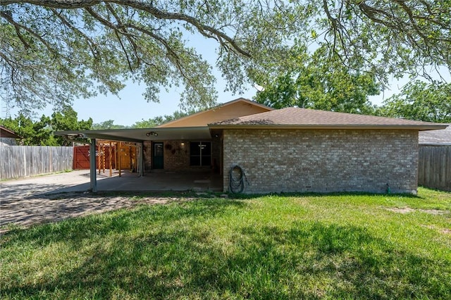 11809 Lori Dr, Corpus Christi, TX 78410 - rear view of property with a carport and brick siding
