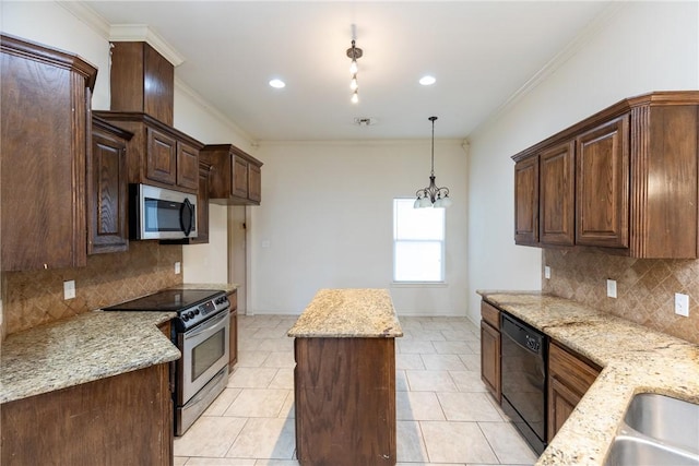 kitchen with appliances with stainless steel finishes, a center island, ornamental molding, and light stone counters