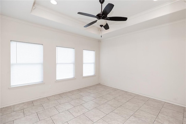 empty room featuring baseboards, ornamental molding, a raised ceiling, and a ceiling fan