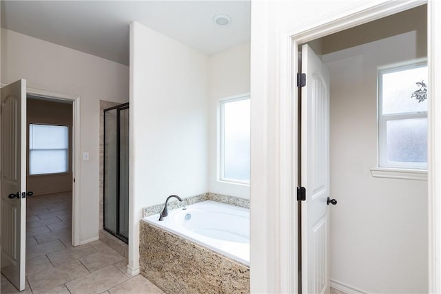 bathroom featuring a stall shower, a garden tub, and tile patterned floors