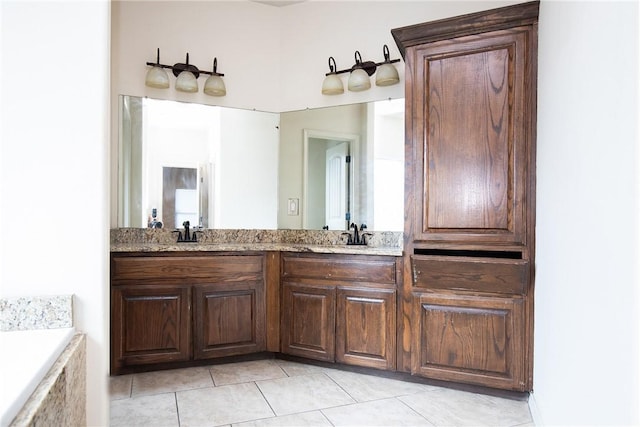 full bathroom with double vanity, a sink, a bathing tub, and tile patterned floors